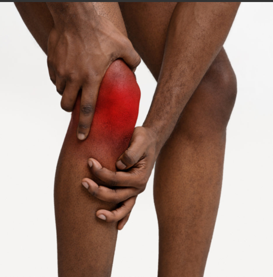 Person holding a red-marked knee, indicating pain or injury.